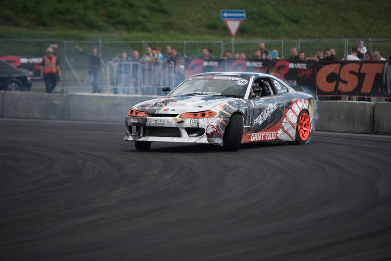 a race car drifting at fast speed along a race track, drift taxi show 4k