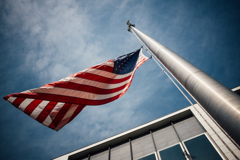 looking up at a flagpole with the american flag flying half mast, flying half mast 4k