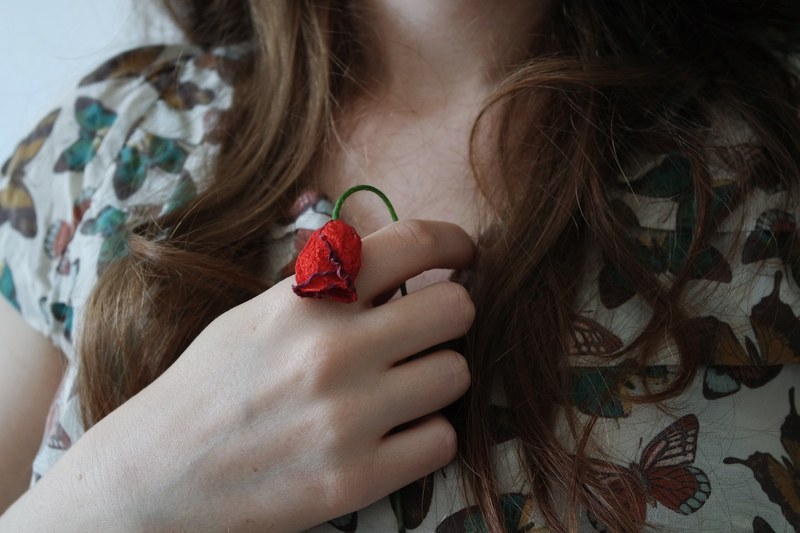 young woman clutches a withered red rose to her heart, withered rose of love 4k