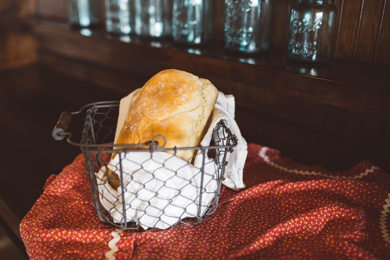 freshly baked loaf of bread in a basket ready to eat, bread on the table 4k