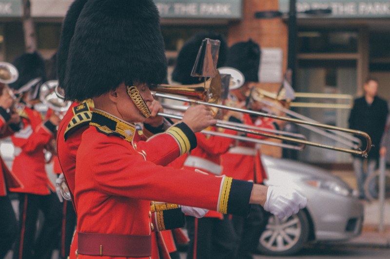 palace guards in bearskin hats playing in a marching band for a parade, palace guard parade 4k