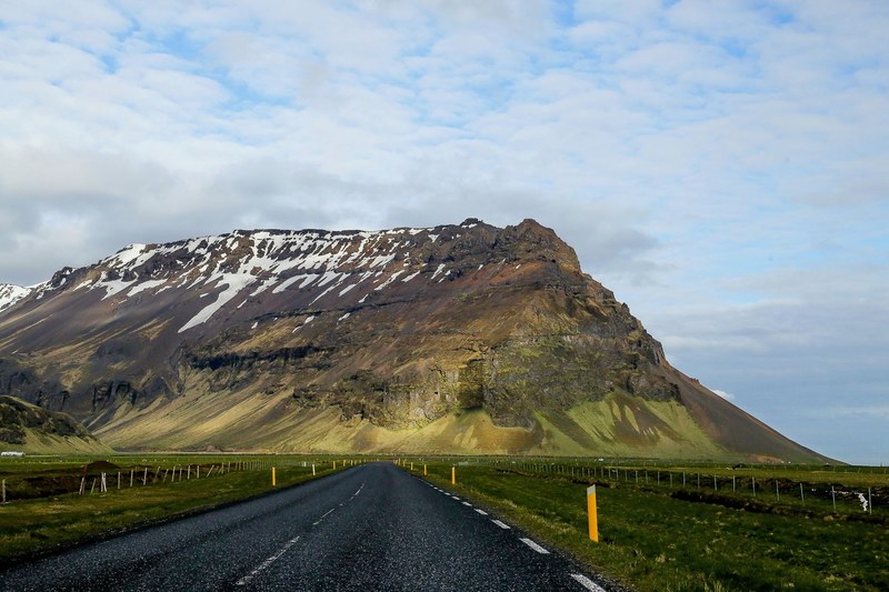 open road leading to a sloping mountain covered in snow, road leading to snowy mountain 4k