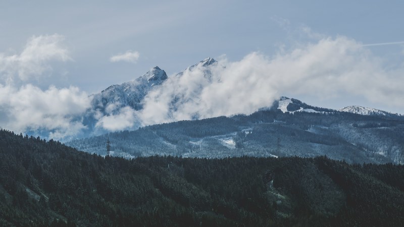 white clouds enveloping snowy mountains in the distance, day 25 unsplashdaily 4k
