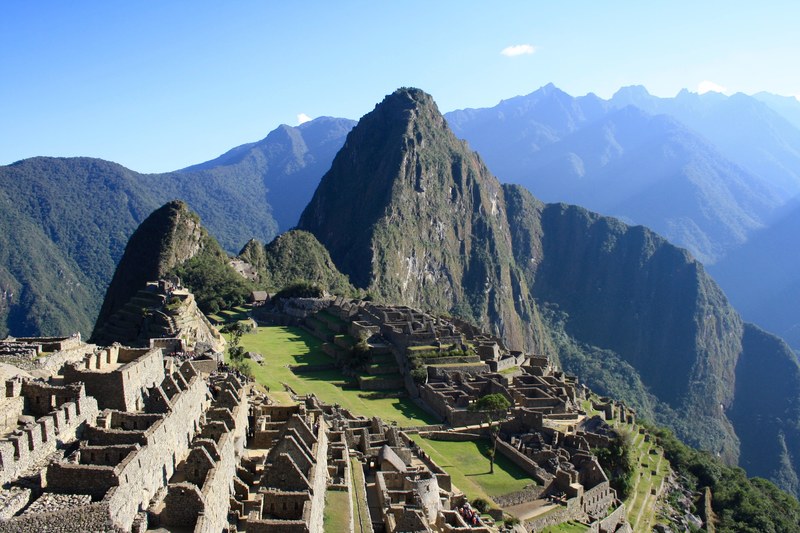 a mountain ridge with the ruins of machu picchu on a sunny day, blue sky over machu picchu 4k