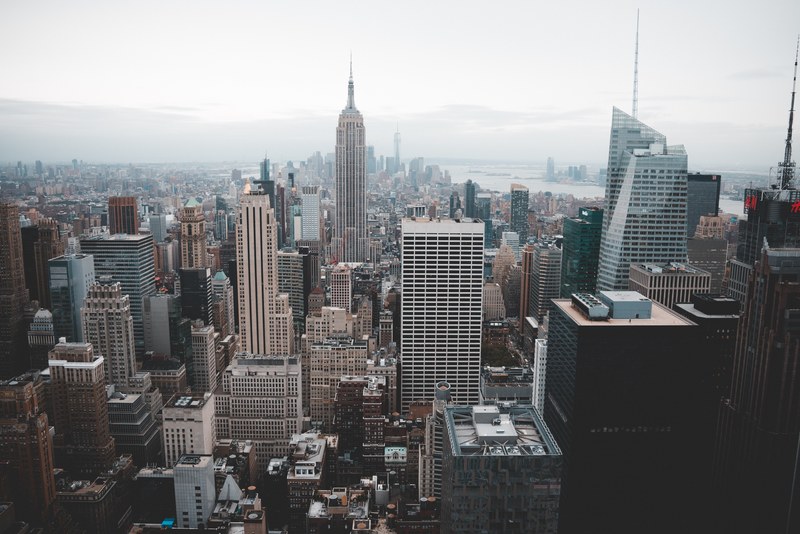 the new york city skyline with the empire state building on a cloudy day, the city that never sleeps 4k