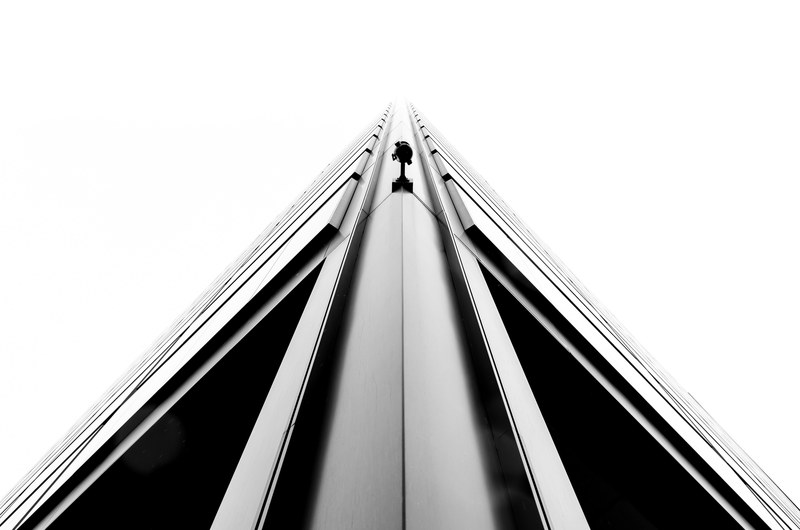 a monochrome shot of a sharp edge on a corner of a tall building, monochrome tower camera 4k
