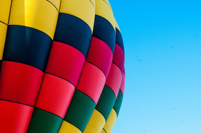 the colorful surface of a hot air balloon against a blue sky, hot air balloon on blue sky 4k