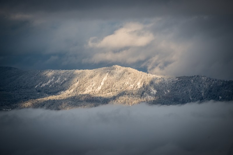 mountains peeking through heavy fog at la muraz, low mountain ridge 4k