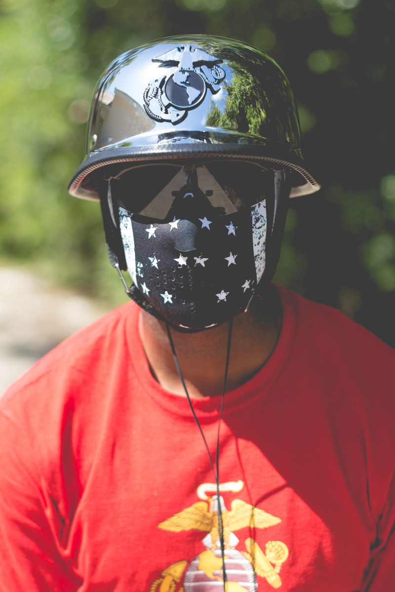 a man in a helmet and t shirt with us marine corps logo and a face mask, noel 4k