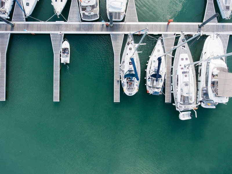 a drone shot of several yachts moored at a marina, luxury yachts at a marina 4k