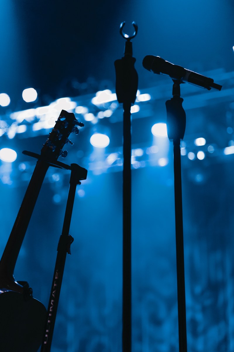silhouette of microphones and guitar on stage at concert in germany, stage 4k