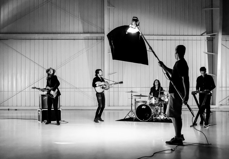 a black and white shot of a rock band playing under artificial light, on set ii 4k