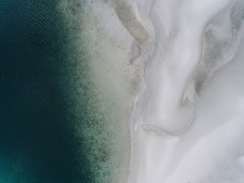 drone view of white sand coastline at belitung, blending in 4k
