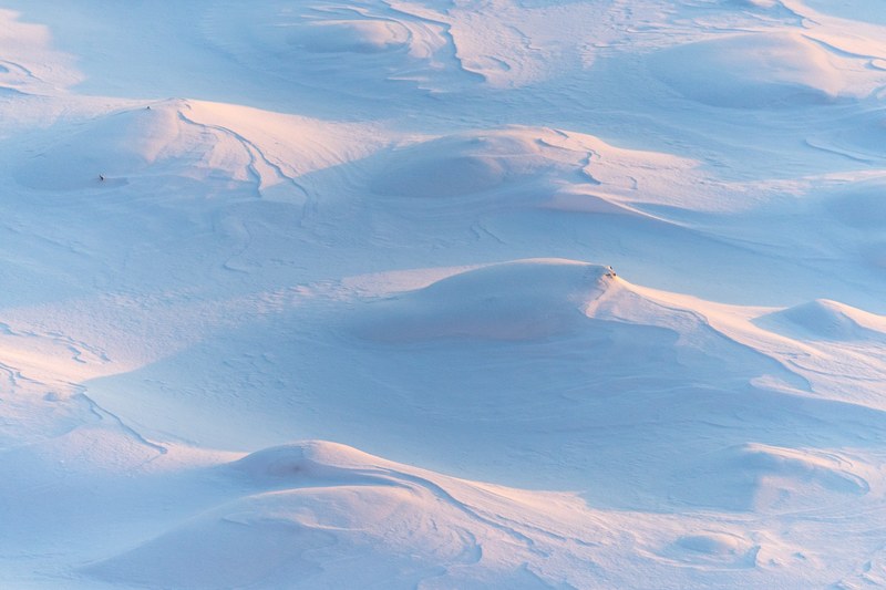 mounds of snow covering the ground on a hill in cherepovets russia, snow mountain in russia 4k