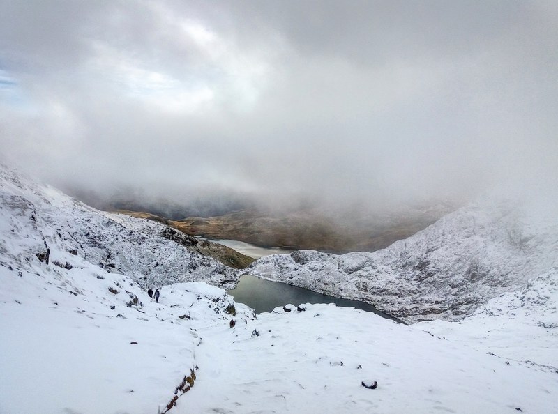 a heavily clouded sky above a lake and hiking valley at nant peris in wales, in the clouds on snowdon 4k