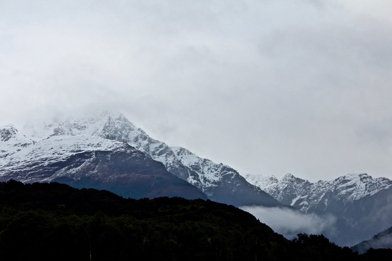 snow capped mountains fade into a foggy sky, mountains in fog 4k