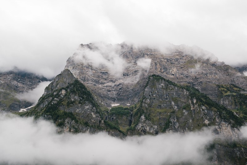clouds over a rocky mountain landscape, fog rolls over netstal 4k