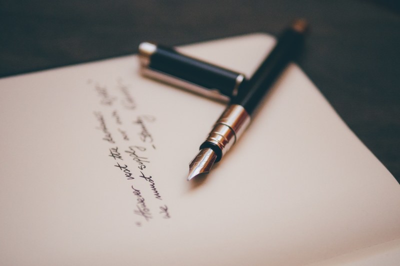 a fountain pen near cursive writing on white stationery, fountain pen on stationery 4k