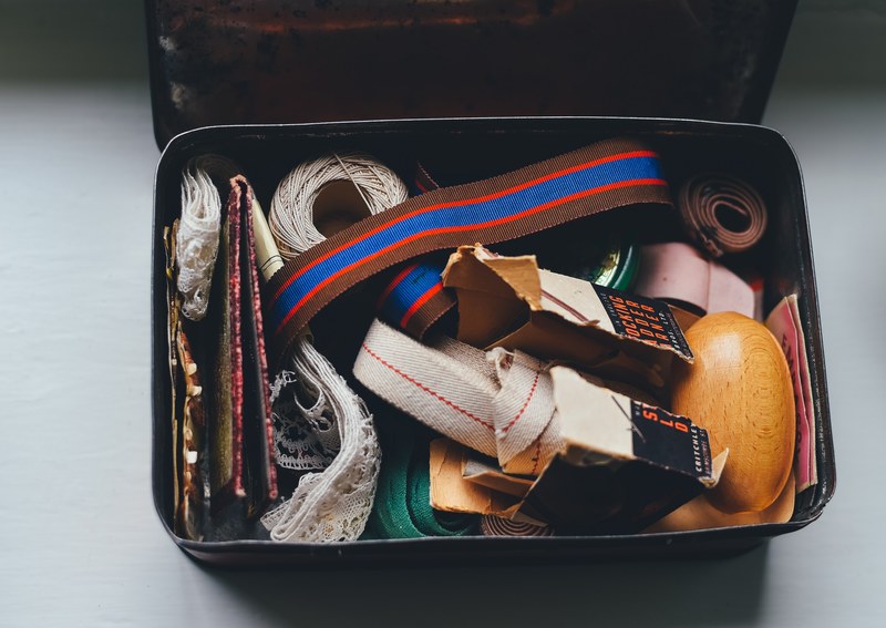 open craft box containing sewing supplies haberdashery and metal buckles, vintage sewing box 4k