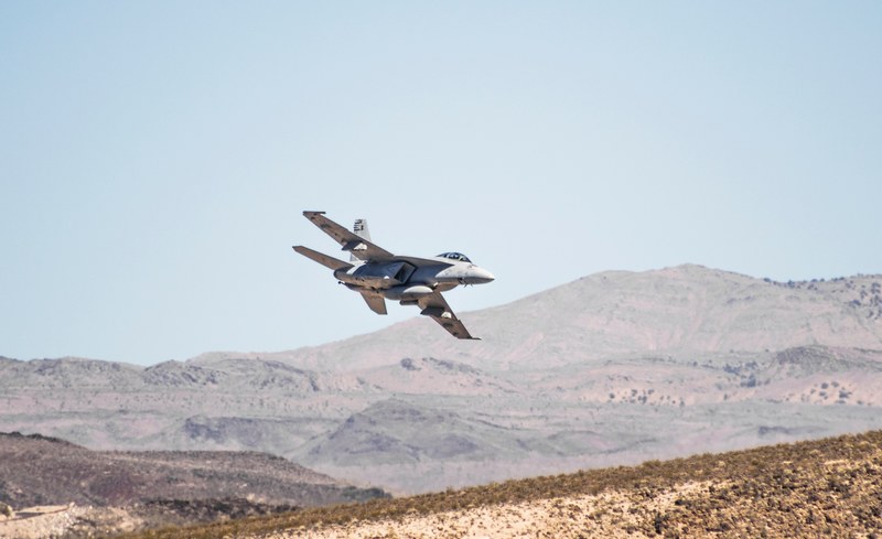 military airplane flies over the desert, training fa 18 in nevada desert 4k