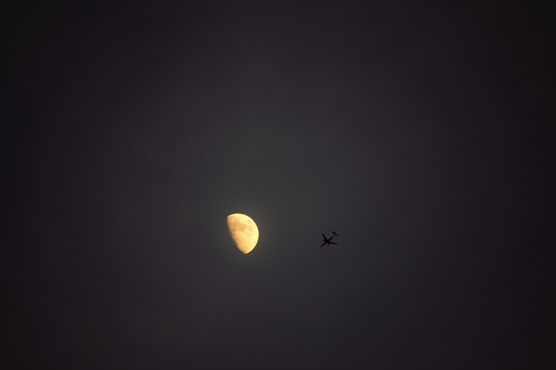 the night sky with a half moon and a plane flying by, plane and moon 4k