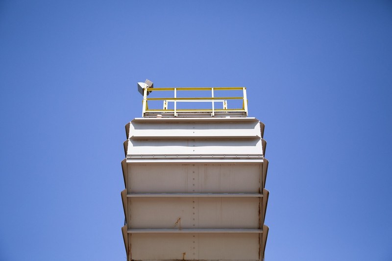 a low angle shot of a high steel platform against a blue sky, observation platform 4k
