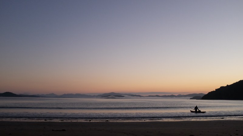 fisherman near the beach in a boat after sunset at russell, fisherman in a boat 4k