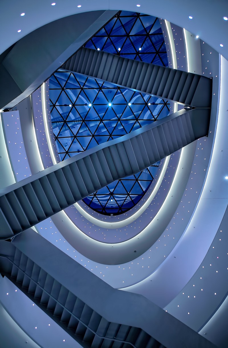 staircases under a modern ceiling with a skylight in a shopping mall, blue stairs 4k