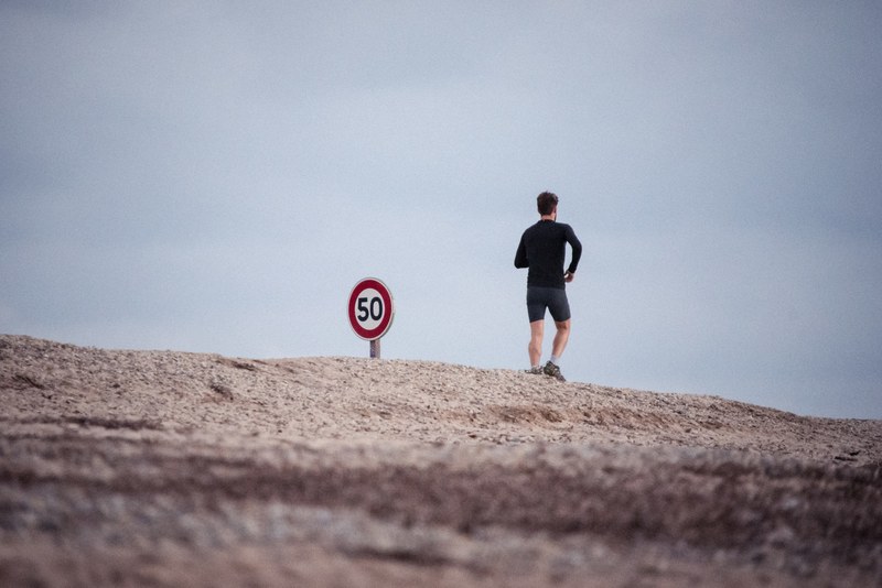 a man jogging outside in hyres france, guy jogging by sign 4k