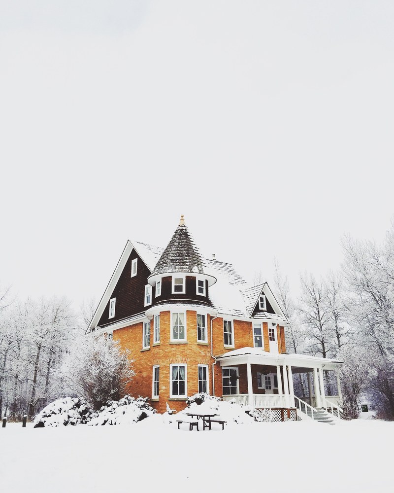 an elegant house with a turret covered in snow in winter, elegant house under snow 4k