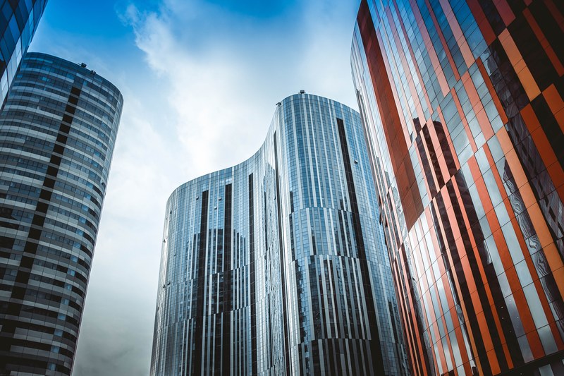 several buildings with curved architecture and reflective surfaces in soft light, _a day passed beijing sanlitun soho 4k