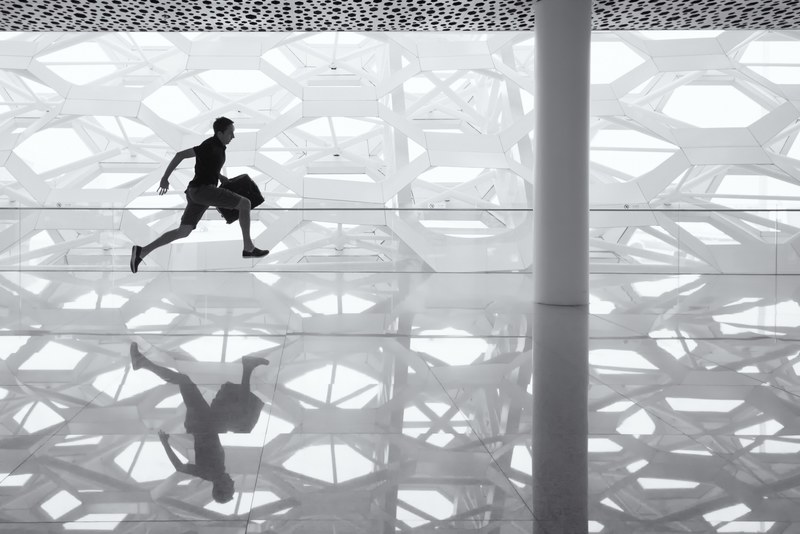 a man running with a briefcase at shenzhen baoan international airport, running in an airport 4k