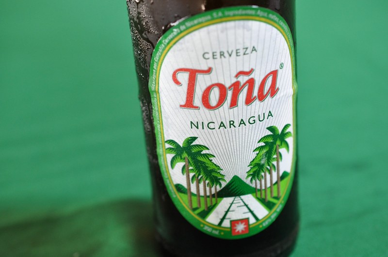the macro view of a green tone beer drink in nicaragua, tona beer drink 4k