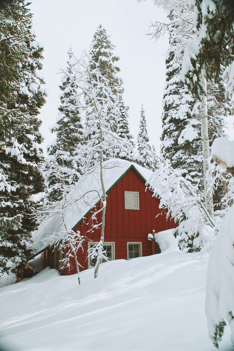 a snow covered house shaped as a trial on a winter hill in solitude nordic center in utah, solitude ski resort 4k