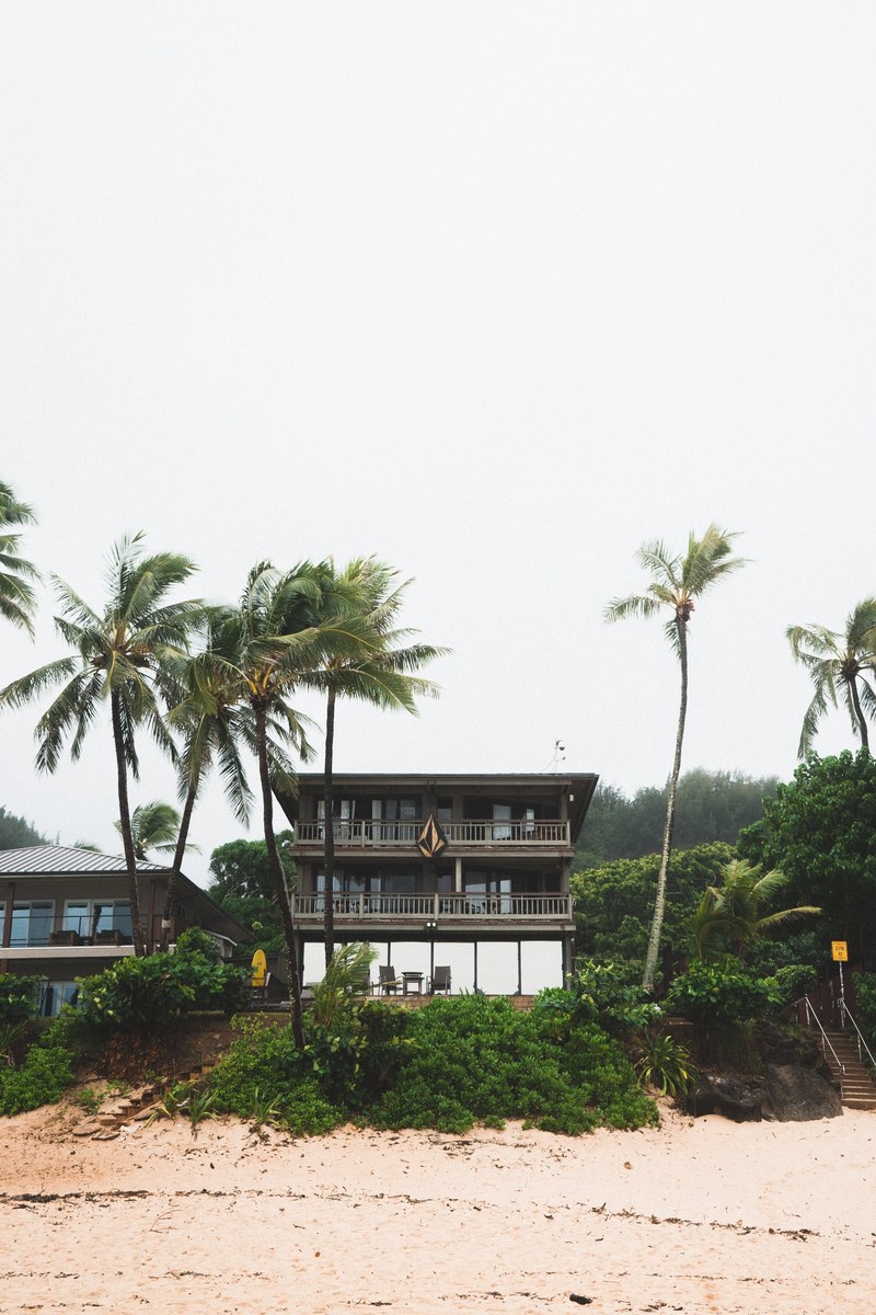 tropical two stories house by the palm trees on the sand beach, beachside house 4k