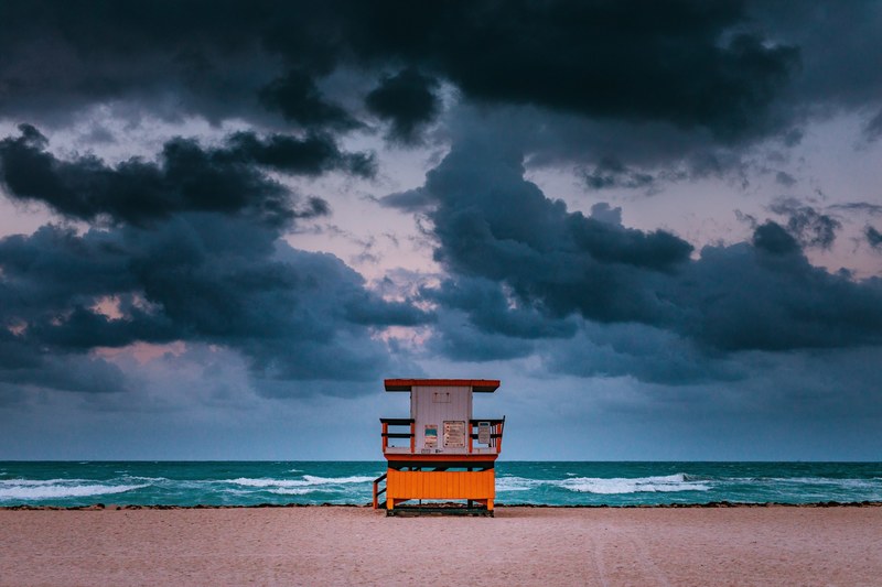 lifeguard hut on the sand beach in miami on a day with storm clouds, lifeguarded 4k