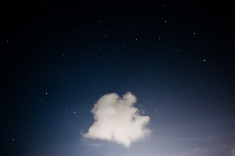 a lone fluffy cloud against a dark sky speckled with stars, cloud against a starry sky 4k