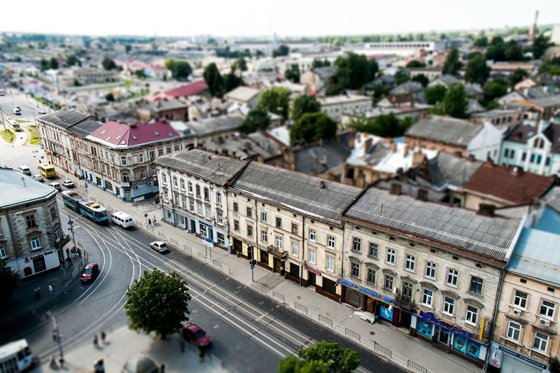aerial view of a suburban setting with houses and buildings in a neighborhood with cars and people on the street, suburban neighborhood 4k