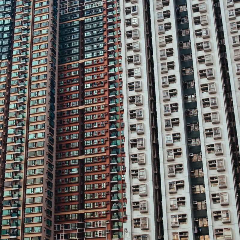 long shot of multi colored high rise apartment buildings with windows, high rise apartment windows 4k