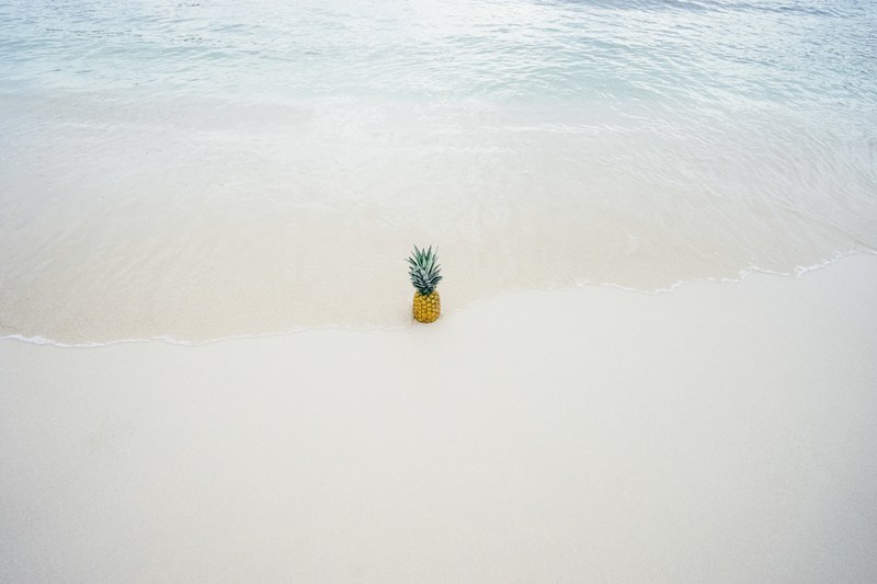 ocean washing ashore with the pineapple in the beach sand, pineapple in the beach sand 4k