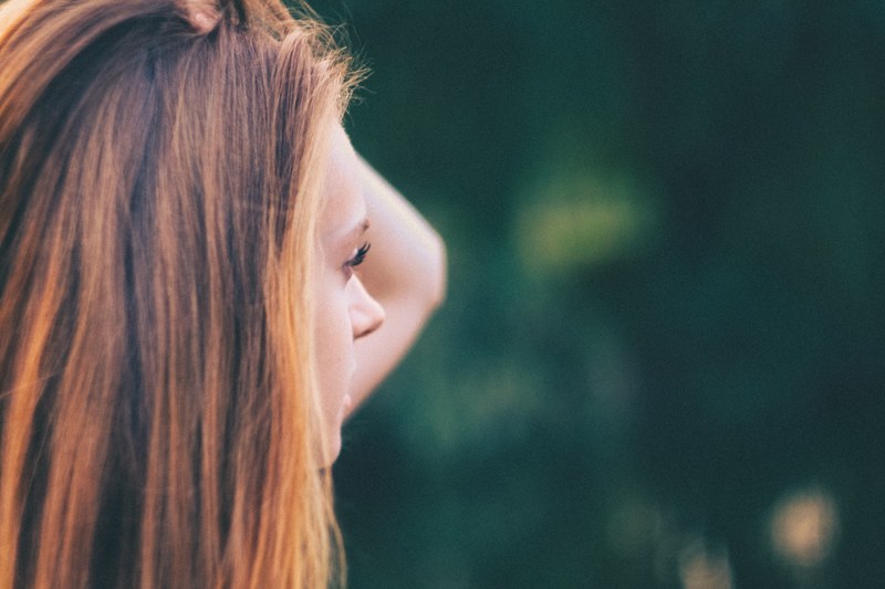 woman with brown and red hair looking into the distance, woman looking into distance 4k