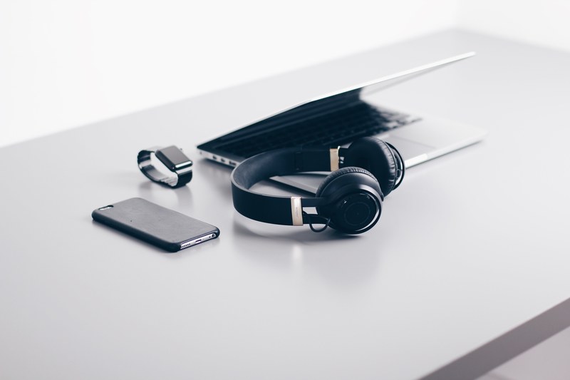 a macbook an iphone an apple watch and headphones on a white desk, technology on a desk 4k