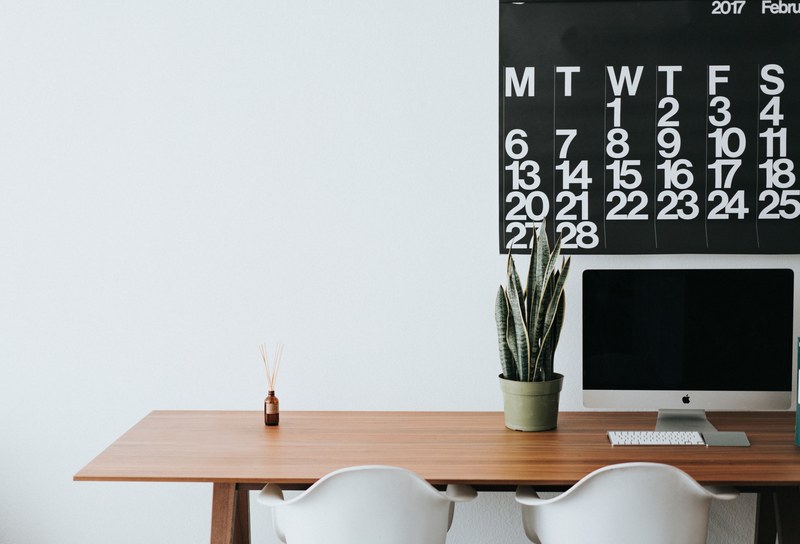 a minimalist shot of a clean office desk with two white chairs and an apple all in one computer, clean minimalist office 4k