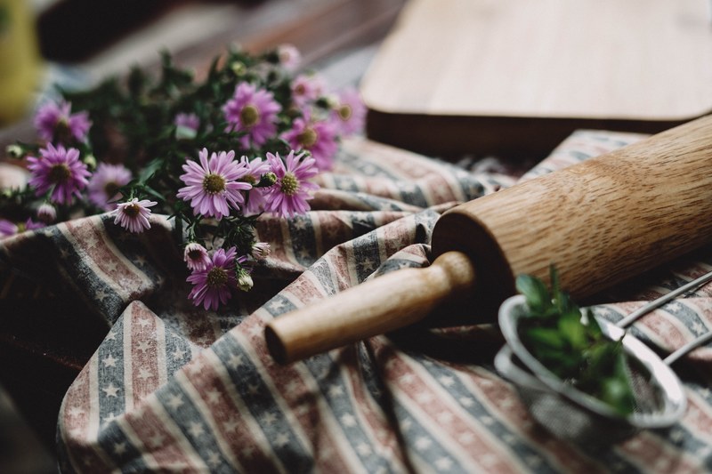 a bunch of pink daisies next to a rolling pin, flowers for grandma 4k