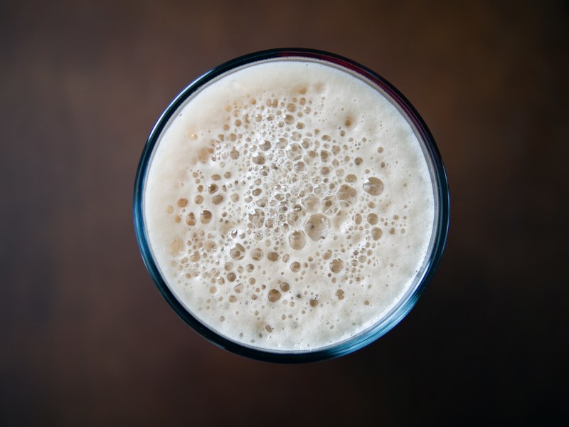 macro view of the top of a drink with foam in a glass british columbia, the top of foamy drink 4k