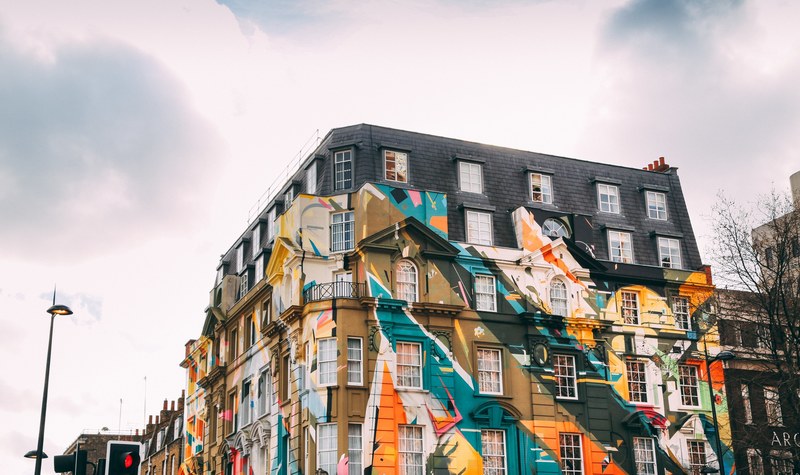 windows on building covered in colorful graffiti artwork mural in shoreditch during daytime, shoreditch graffiti windows 4k