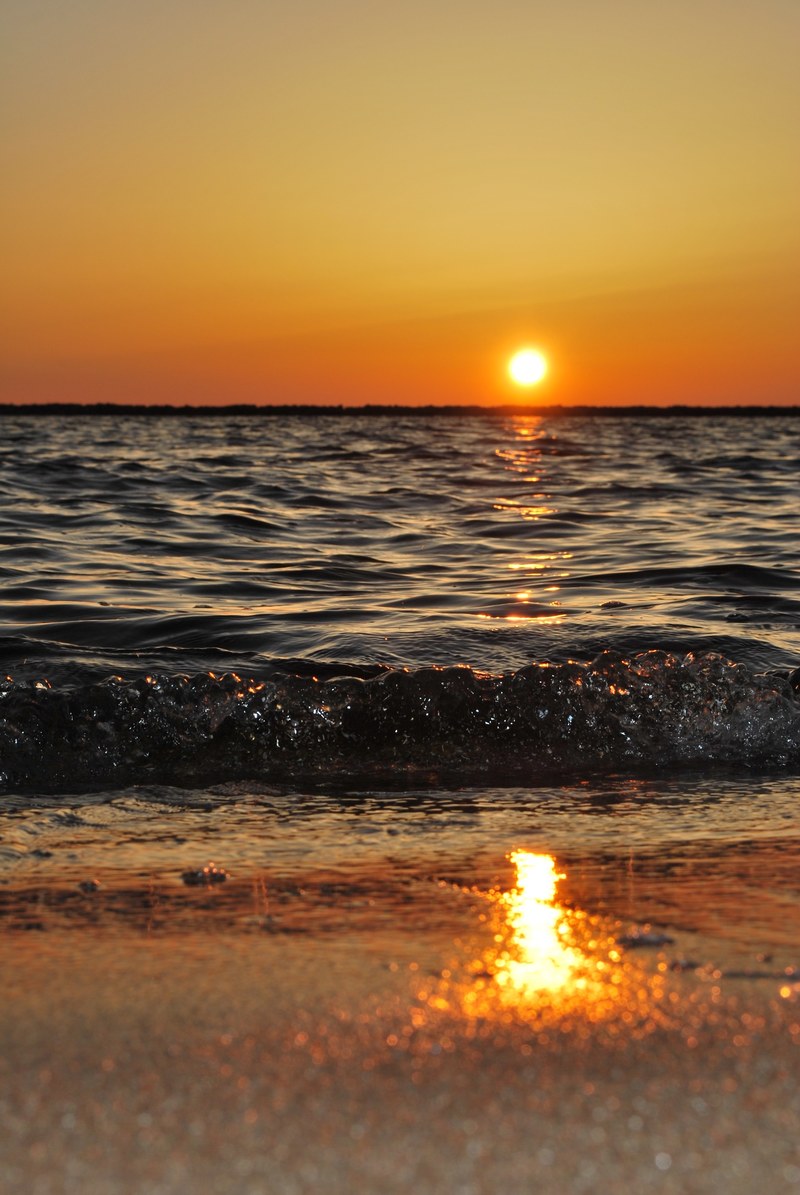 horizon features mild yellow atmosphere and dark ocean on beach view in sunrise, warm sunrise on beach 4k