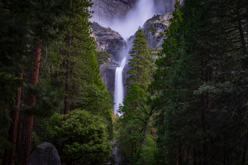 a frothy waterfall pouring down a rock formation in yosemite valley, lower yosemite falls 4k
