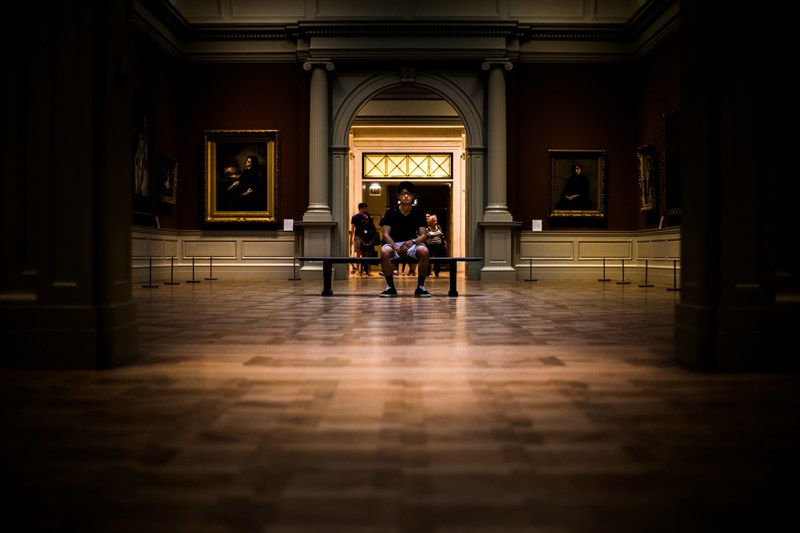 man sitting on a bench inside the metropolitan museum of art, night at the museum 4k
