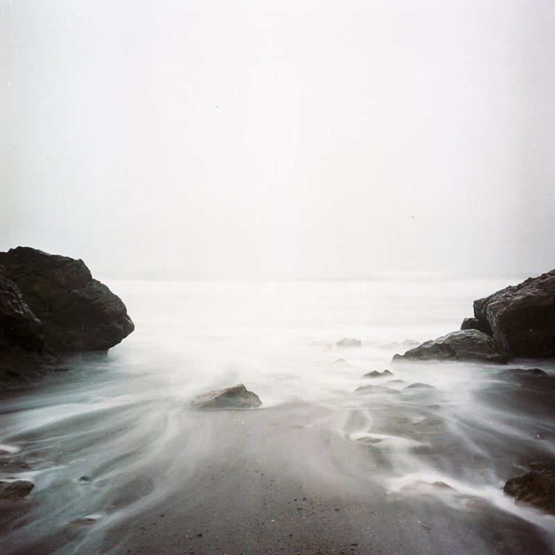 long exposure photo of the ocean coming in the rocky bay, sea salt 4k